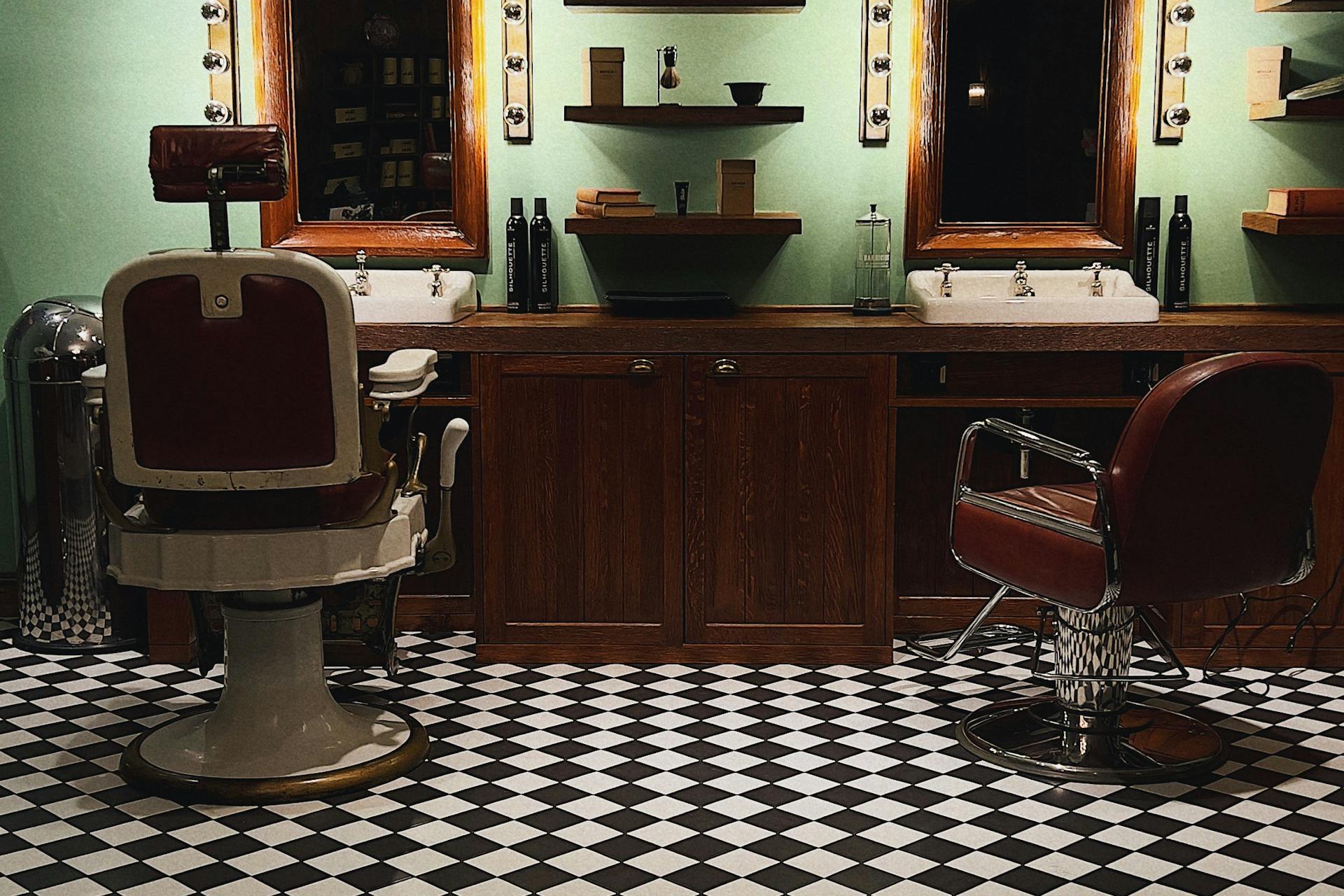 Vintage leather barber chair in dark wood Mayfair-style interior