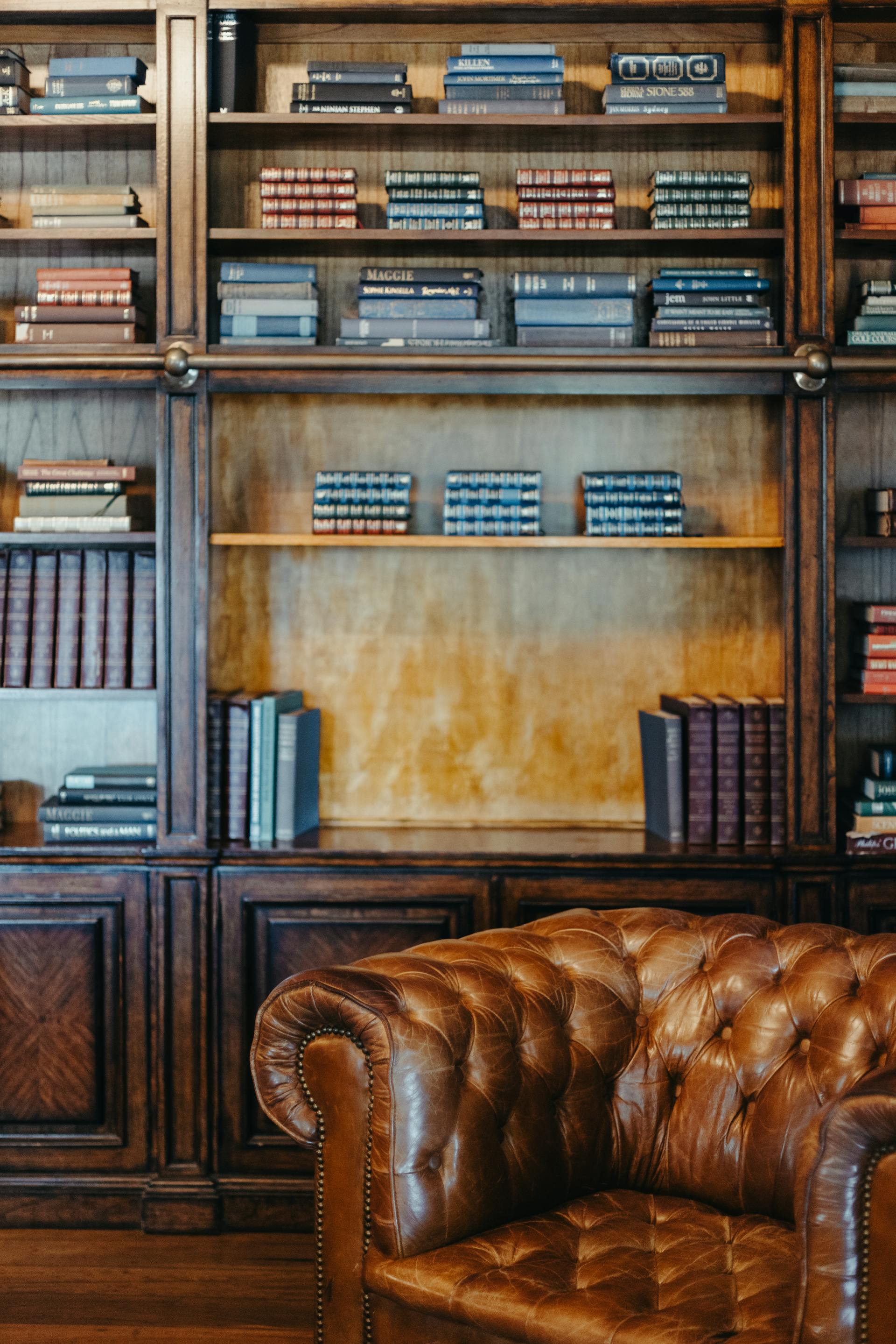 Mahogany bookshelf and tufted leather chesterfield in the reading lounge